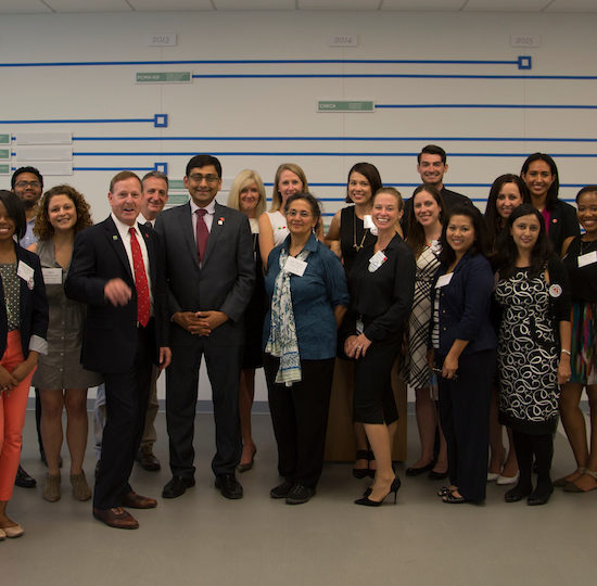group photo of population health sciences staff in front of colorful background