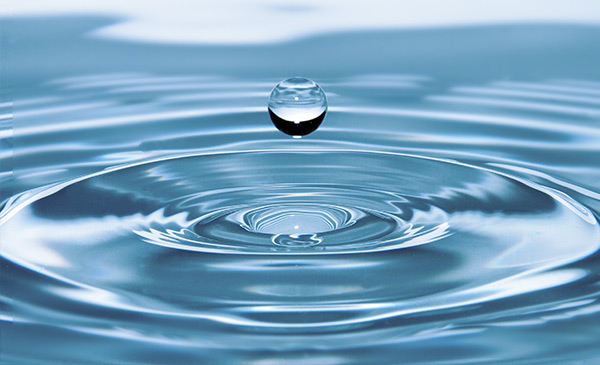 drop of water splashing and causing ripples