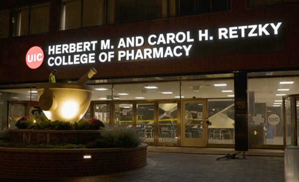 The new College of Pharmacy exterior sign illuminated at night