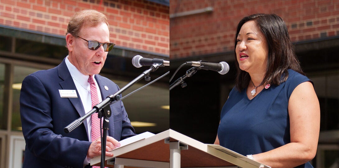 At left, a photo of a man in wearing a dark blue suit and red neck tie standing at a podium and speaking into a microphone. At right, a woman in a dark blue dress standing at a podium and speaking into a microphone.